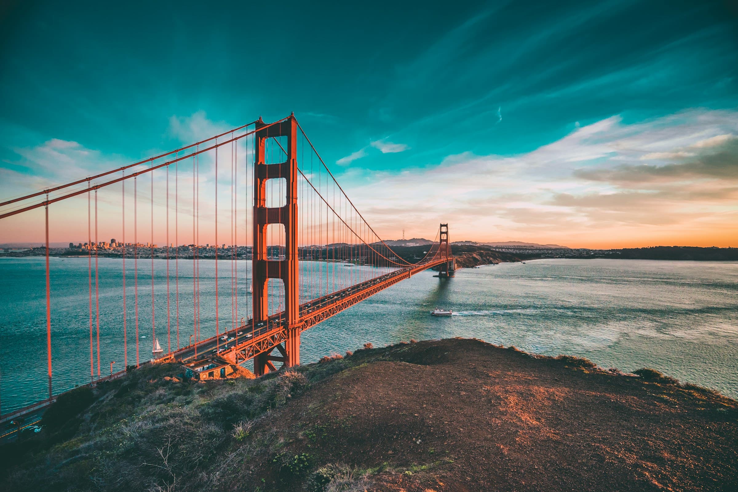 Golden Gate Bridge seen from a Marin lookout with green hills and the bay